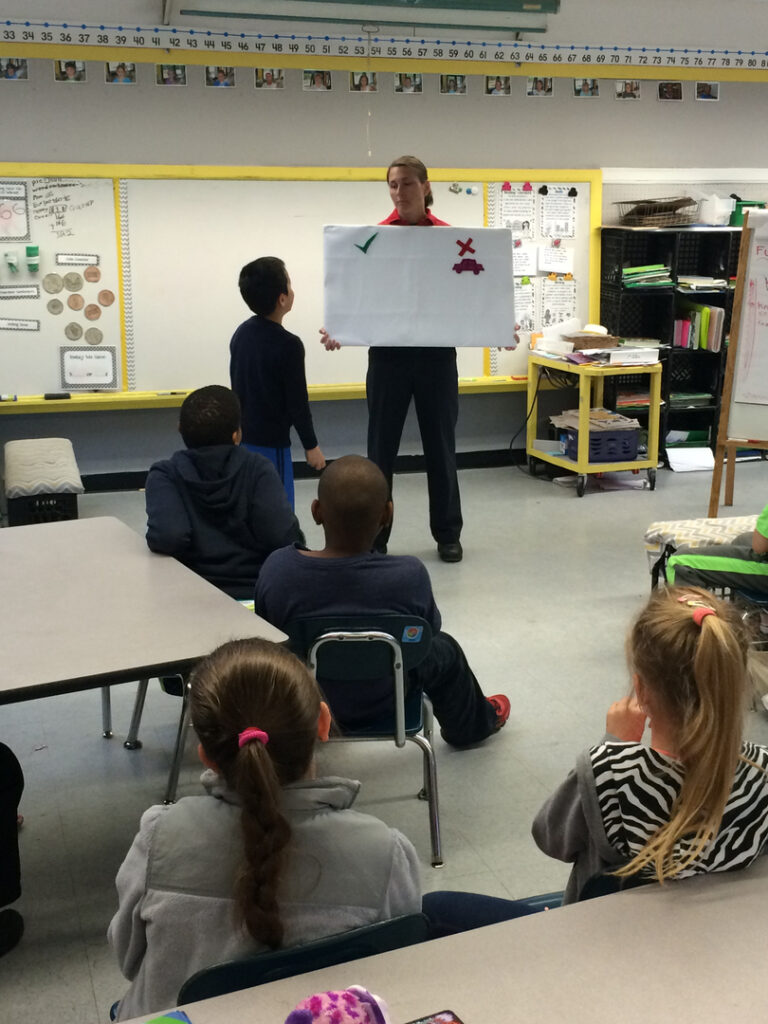A firefighter talks to students in class during the 2015 Student SAFE event.