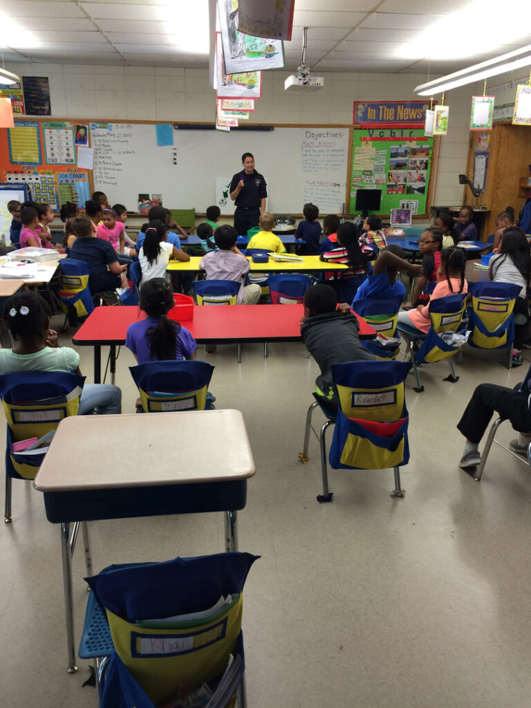 A firefighter talks to students in class during the 2015 Student SAFE event.