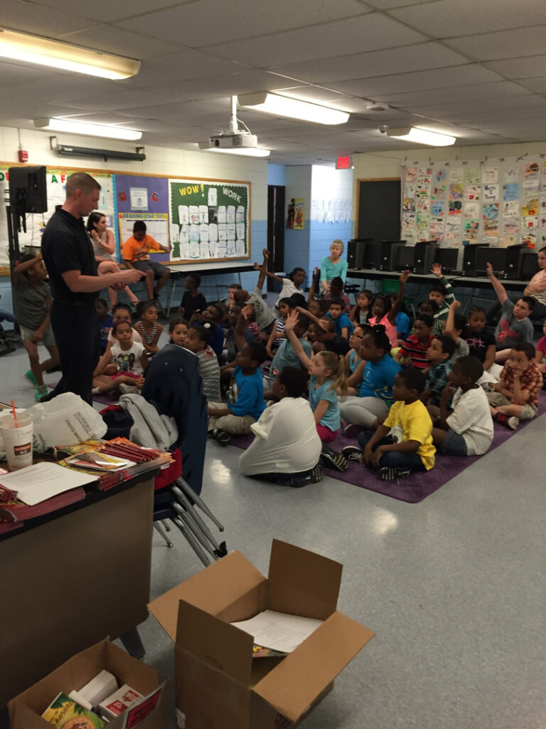 A firefighter talks to students in class during the 2015 Student SAFE event.