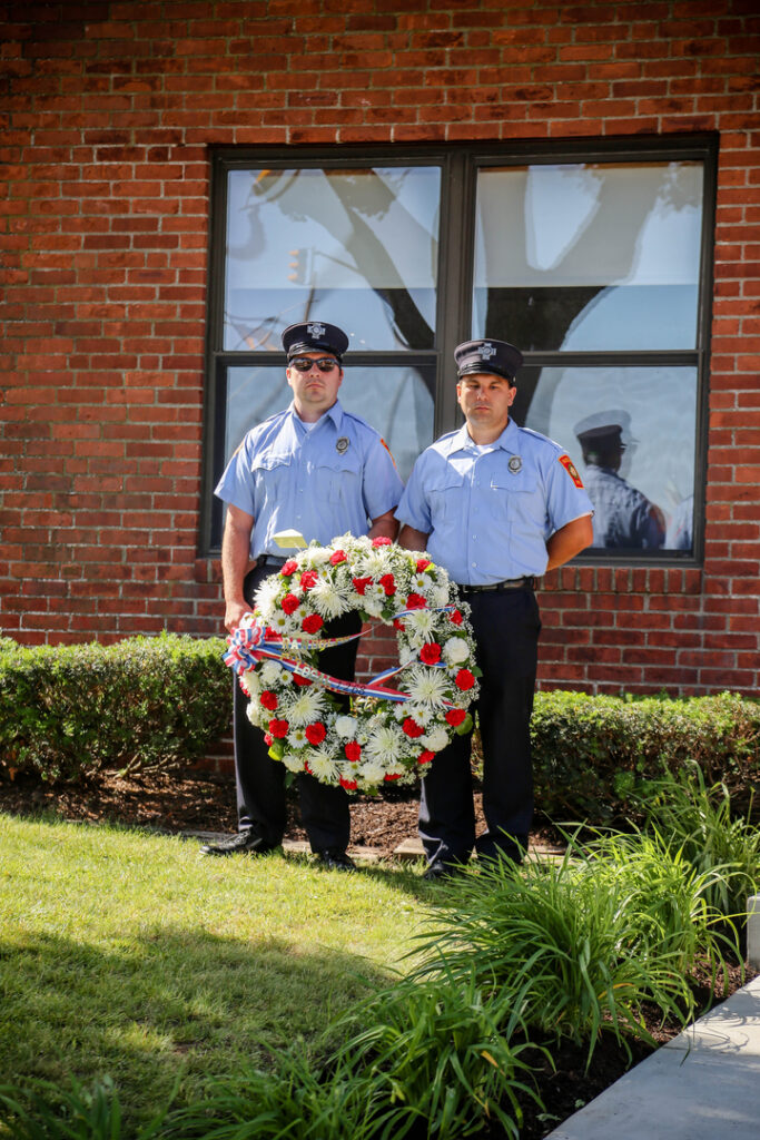 Two fire fighters with a flower decoration during the 2016 fire fighter Sunday celebration.